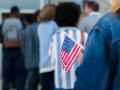 Woman holds American flag on election day