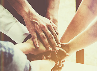 group of hands together in a huddle